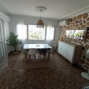 a kitchen and dining room with a table and chairs at Villa Manuela in Denia