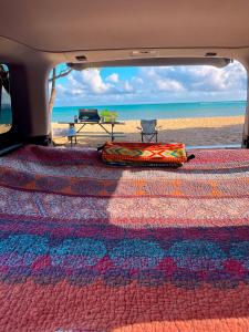a rug in the back of a van on the beach at Go Camp Maui-Exploring Maui in a Campervan in Ah Fong Village