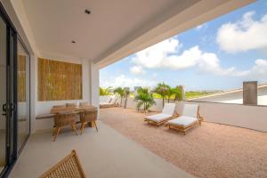 an open living room with a view of the ocean at Villa NOMA - Apartment w/ Lovely View I 5 min/Beach I Free SUP in Willemstad