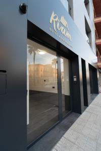 a store front with a sign on the side of a building at Riam suites apartamentos in Los Palacios y Villafranca