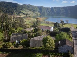 an aerial view of a farm with a lake and mountains at Sete Cidades Lake Lodge in Sete Cidades