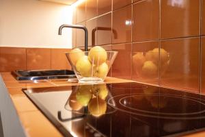 a kitchen counter with a bowl of fruit on a stove at Suite de lujo estilo mediterráneo in Valencia