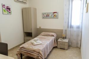 Cama ou camas em um quarto em Villa Pollina