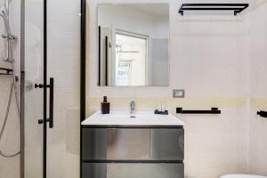 a bathroom with a sink and a mirror at Aventino Industrial Loft in Rome