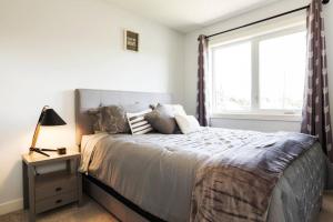 a bedroom with a large bed and a window at Modern Home - King Bed - Garage - Long Stays in Edmonton +51 photos