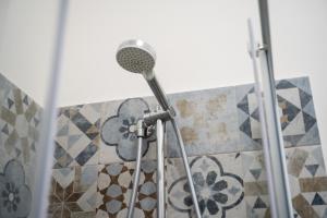 a shower with a shower head in a bathroom at Villa Pollina in Buseto Palizzolo