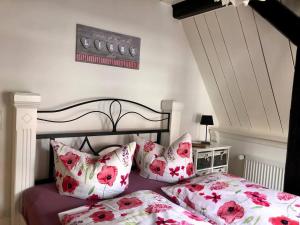 a bedroom with a bed with pink and white pillows at First Class Ferienwohnung mit Sauna, Bar u. Wirlpool in Steinhude in Steinhude