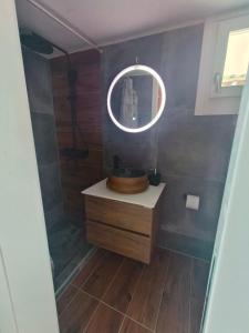 a bathroom with a sink and a mirror at Enjoy sunset from a wonderful traditional studio-Melina in Ioulis