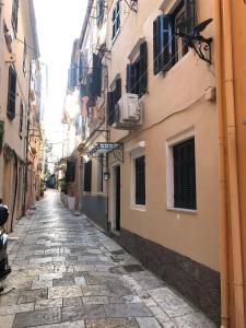 an alley in an old city with buildings at M&F 1 Studio in Old Town in Corfu
