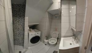 a small bathroom with a toilet and a sink at M&F 1 Studio in Old Town in Corfu