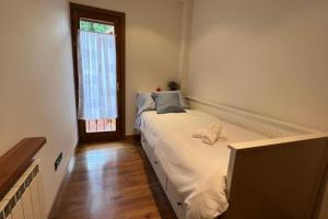 a bedroom with a large bed with a window at Fantástico apartamento con vistas a Llivia in Llivia +15 photos