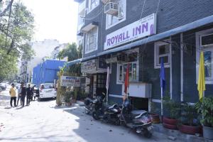 a group of motorcycles parked outside of a building at Hotel Royal Inn in New Delhi