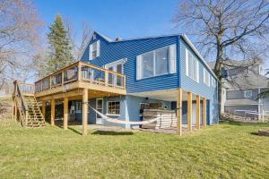 a large blue house with a porch and a deck at Delton Lake House with Boat Dock Fish, Swim and More! in Orangeville