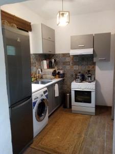 a kitchen with a washing machine and a washer at Family house near the sea in Kokkala