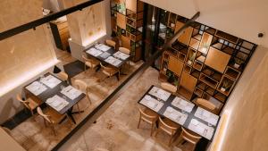 una vista aérea de un restaurante con mesas y sillas en METEORON Luxury Rooms, en Matera