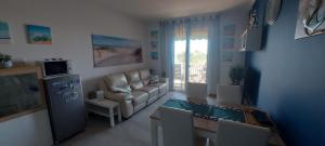 a living room with a couch and a table at Seaview Beach Front Grado Pineta Andromeda in Grado-Pineta