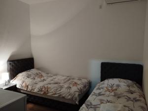 a bedroom with a bed and a bedskirts at Apartmani Ćosić - Kuršumlijska banja in Kursumlijska Banja