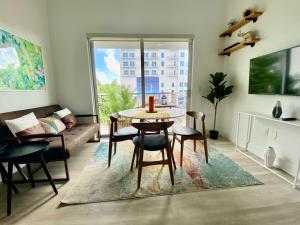 a living room with a table and a couch at Aerie Apartments in Miami