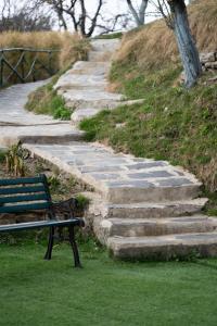 a park bench sitting next to a set of stairs at Eden Estate Cottages x THHPlife - Mashobra in Mashobra