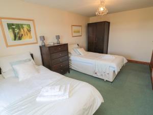 a hotel room with two beds and a dresser at The Retreat in Alnwick +32 photos
