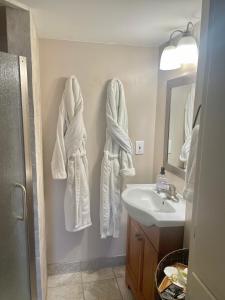 a bathroom with white towels hanging on the wall at City light views getaway close to top ski resorts in Salt Lake City