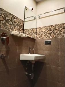 a bathroom with a sink and a mirror at Hotel Windsor Plaza in Hyderabad