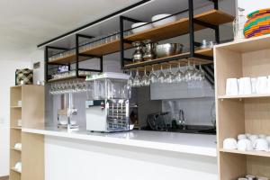 a kitchen with a counter with wine glasses at Hotel Bacata Plaza in Zipaquirá