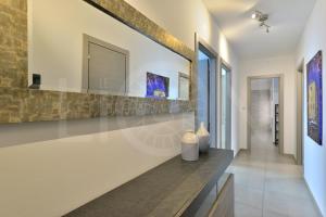 a hallway of a house with two vases on a counter at Le Lion Apartments - Lys Family Apartment in Aosta