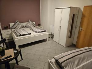 a living room with a bed and a cabinet at Hotel Alt Cues in Bernkastel-Kues