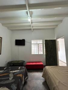 a bedroom with two beds and a flat screen tv at Casa de jose in Manizales