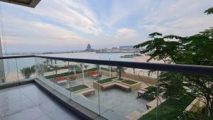 a balcony of a building with a view of the water at Beachfront SeaView Home in Lusail