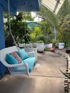 a swinging chair on a patio with potted plants at NovaGarden in San Diego