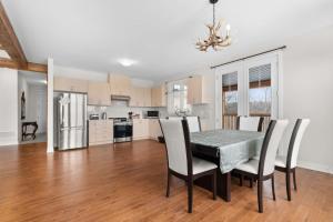 a kitchen and dining room with a table and chairs at Muskoka Retreat Stunning Hilltop Views in Huntsville
