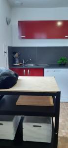a room with a kitchen with a table and a counter at Gîte Au clair de lune in Châtillon-sur-Cher +13 photos