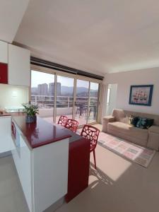 a kitchen and living room with a table and chairs at Ocean Blue in Porlamar