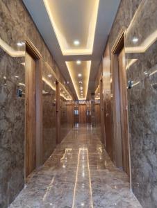 a hallway of a building with marble floors and ceilings at Hotel Windsor Plaza in Hyderabad