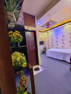 a hotel room with a bed and flowers on the wall at Spas Personal Care in Dhaka