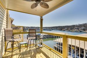 a balcony with chairs and a view of the water at Lakefront Osage Beach Condo with Pool Access! in Osage Beach