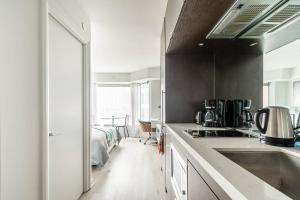 a kitchen with a sink and a counter top at 19th Fl Modern Studio in Yorkville in Toronto