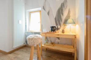 a room with a desk with a lamp and a stool at ILLASI DREAM ROOMS in Illasi