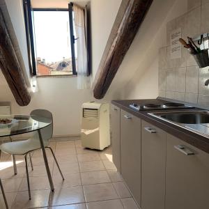 a small kitchen with a table and a sink at Duomo in Turin