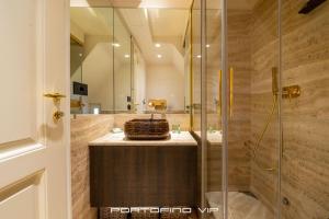 a bathroom with a glass shower and a sink at Da I Gemelli Loft by PortofinoVip in Portofino +18 photos
