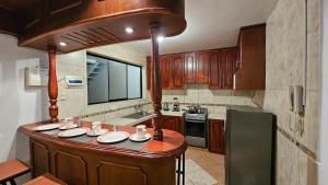 a kitchen with a large island in the middle at Los Profesionales - Hospedaje in Cusco