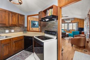 a kitchen with wooden cabinets and a stove top oven at Cornerstone Cabin at Springdale in Canton +18 photos