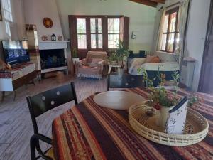 a living room with a table and a couch at Aires de Vistalba in Ciudad Lujan de Cuyo