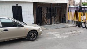 un coche blanco estacionado frente a una puerta en Casa para 4-5 personas, en Lima