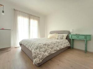 a bedroom with a bed and a blue table at Ericeira Vibes in Ericeira +48 photos
