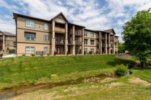 a large apartment building with a lawn in front of it at NEW Const Sleeps 6 Pool - close to Pkwy in Pigeon Forge