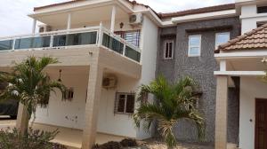 a house with a balcony and palm trees at Al jannah Bis in Somone