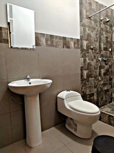 a bathroom with a sink and a toilet at La Ruta in Paracas